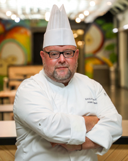 Man wearing chef coat and hat